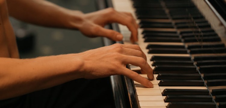 Hands playing the piano